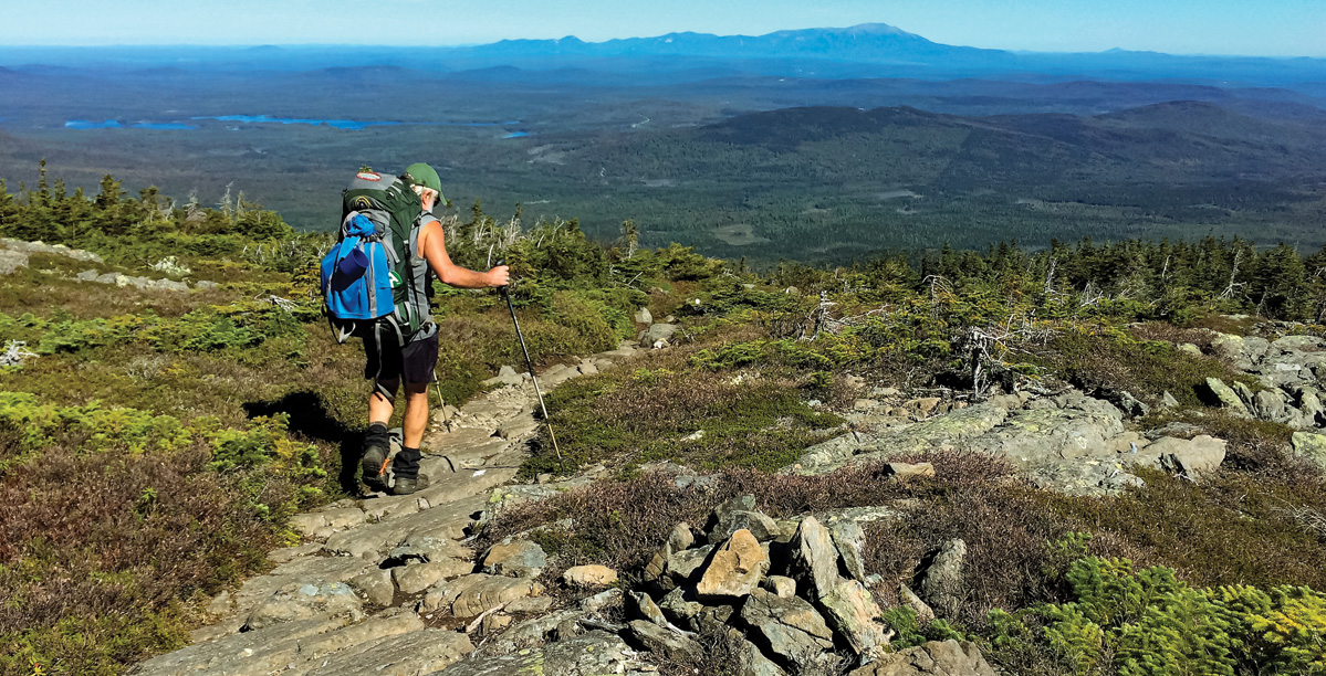 A backpacker on the AT on White Cap Mountain heads north for Katahdin.